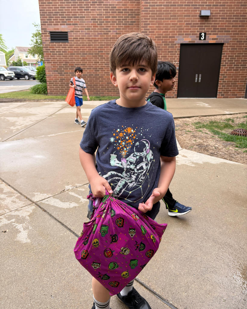 Student carrying a pillowcase as a backpack into school
