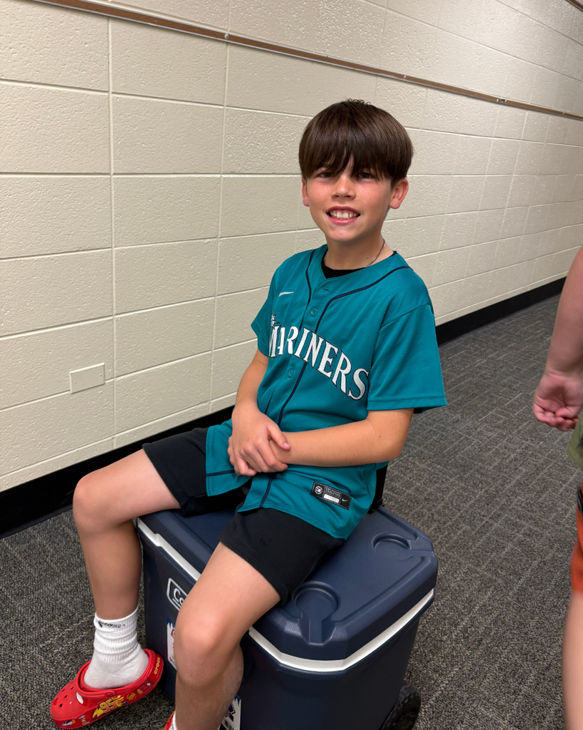 Student sitting on a cooler