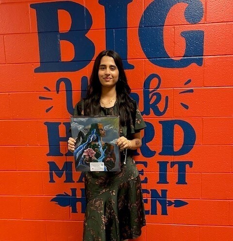 Girl holding her painting