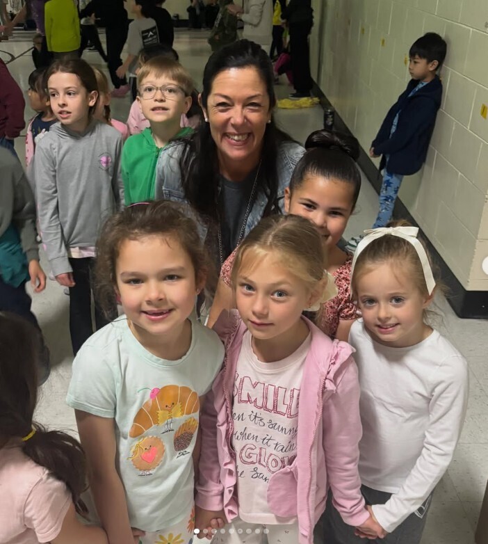 Mrs. Varney and students smiling