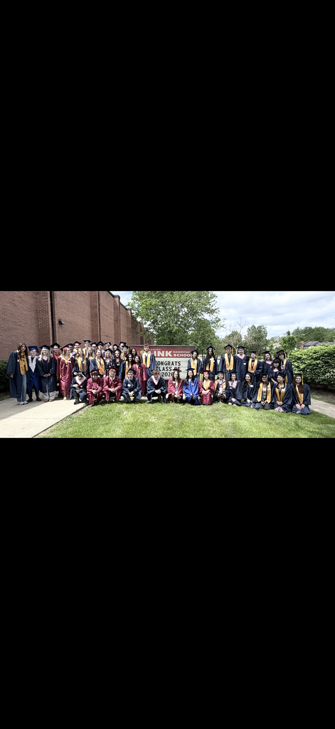 Seniors in front of the Link Elementary sign 