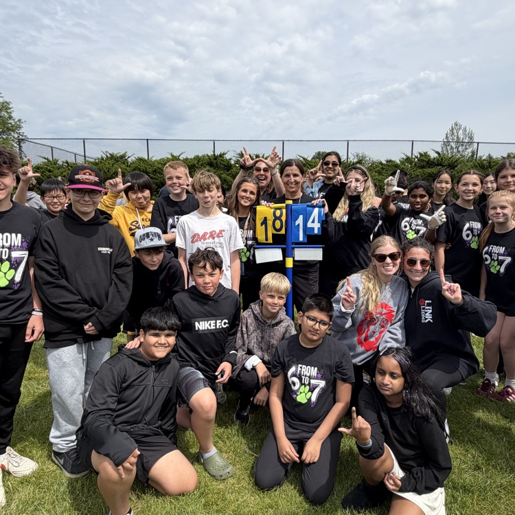staff and students with scoreboard 