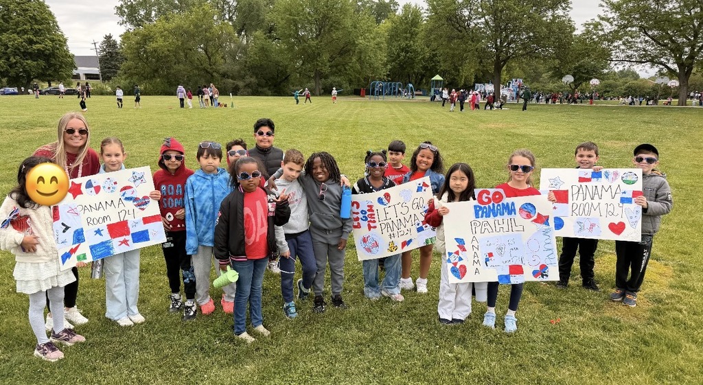 Class outside holding Panama posters