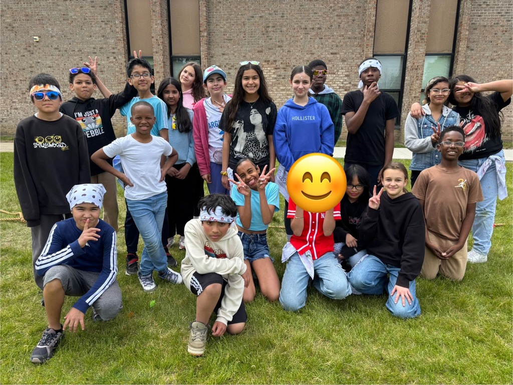 A class posing for a picture outside