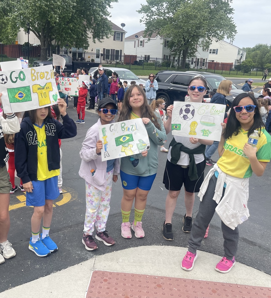 Students outside holing Brazil posters