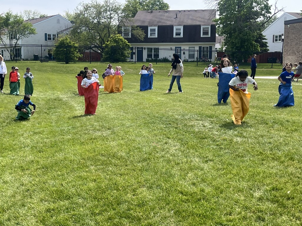 Students competing in a potato sack race