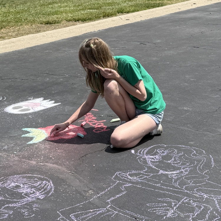girl coloring with sidewalk chalk