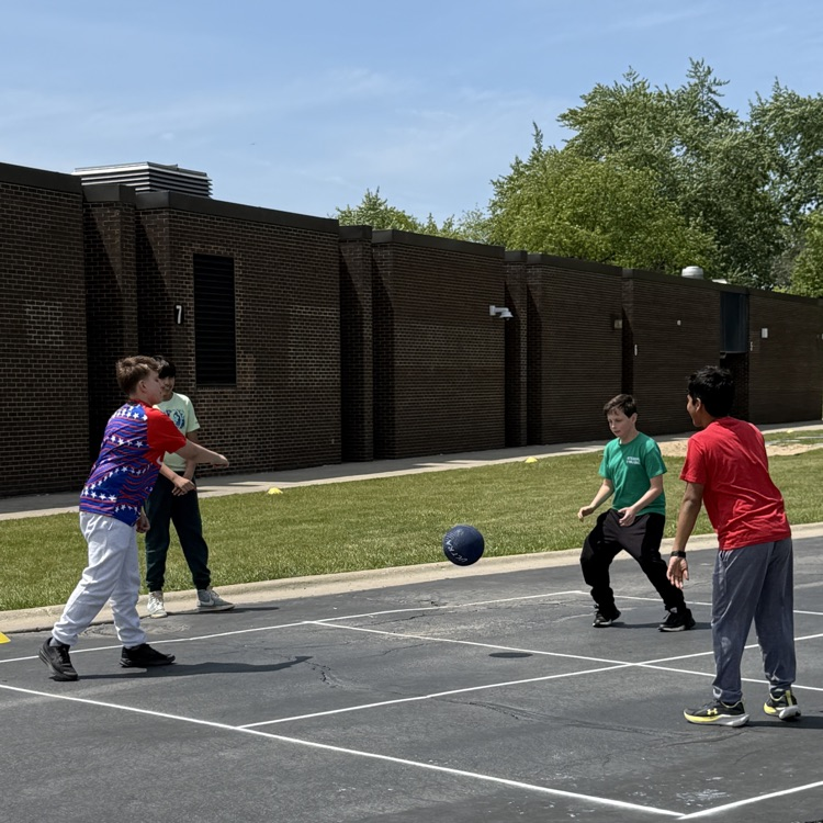 boys playing four square outside
