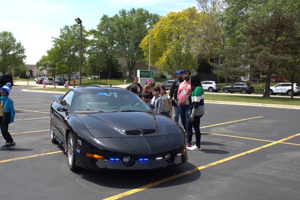 Students looking at a car