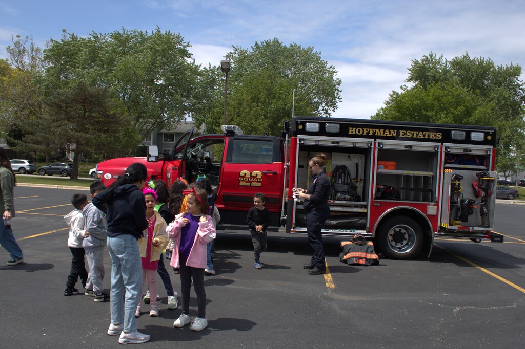 Students standing by a recue vehicle
