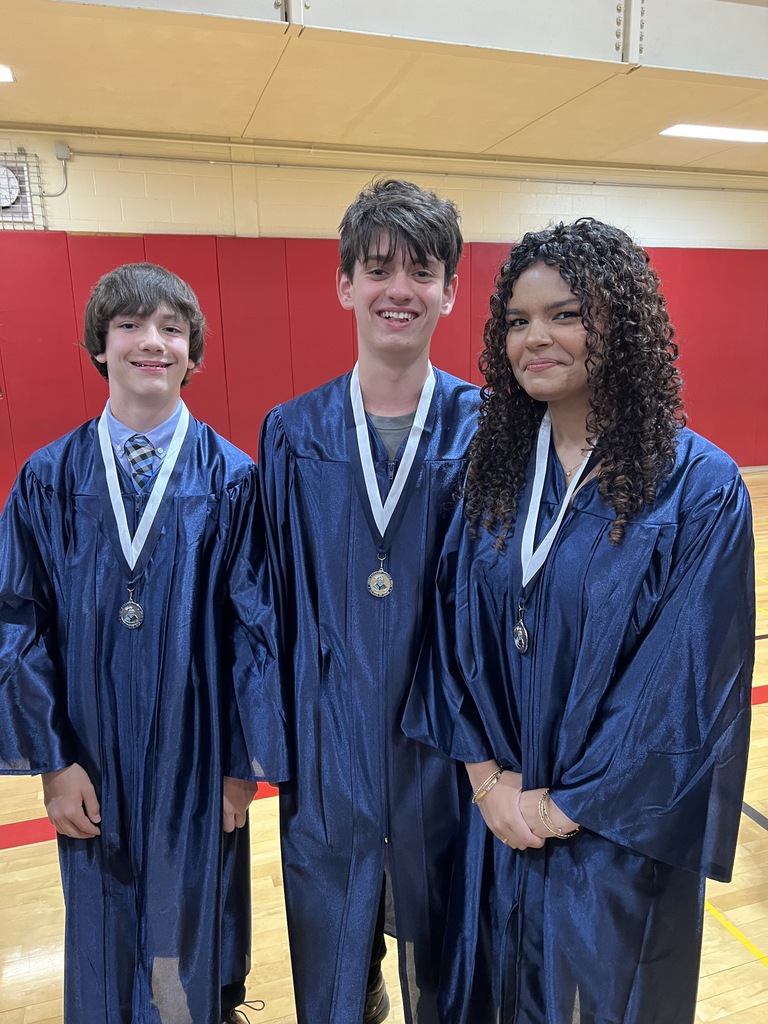Students posing in their graduation gowns