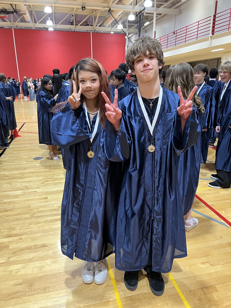 Students posing in their graduation gowns