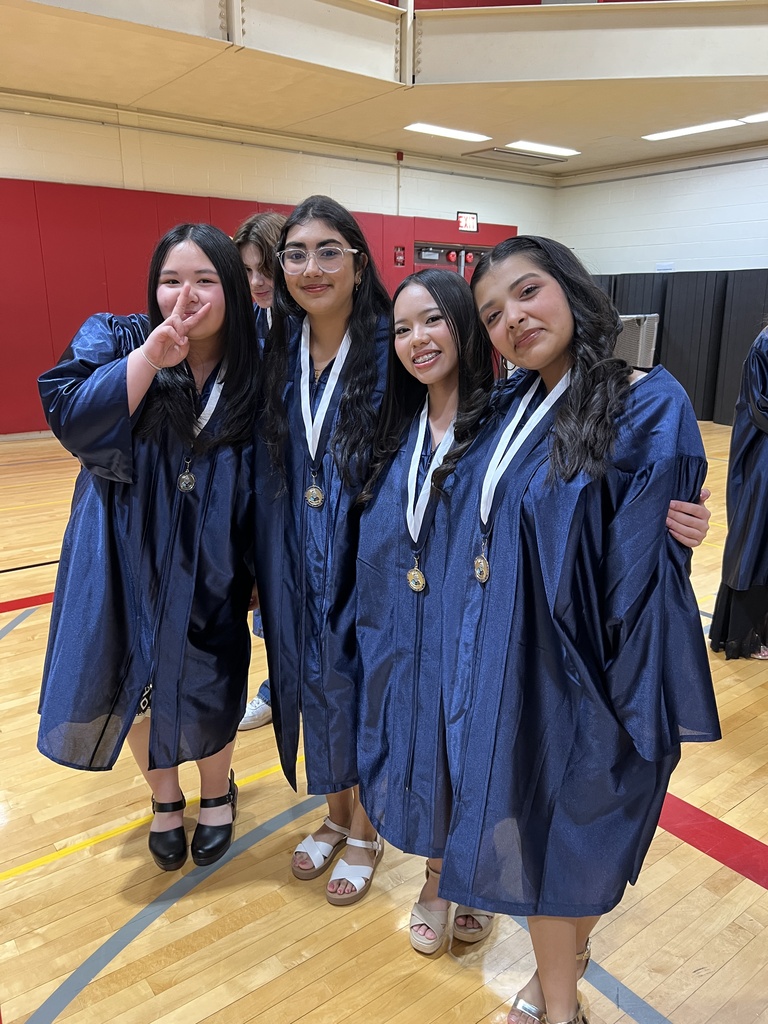 Students posing in their graduation gowns