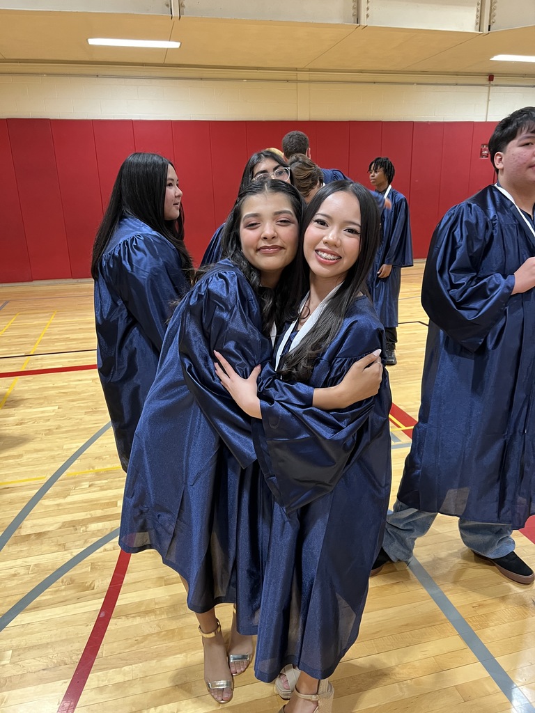 Students posing in their graduation gowns