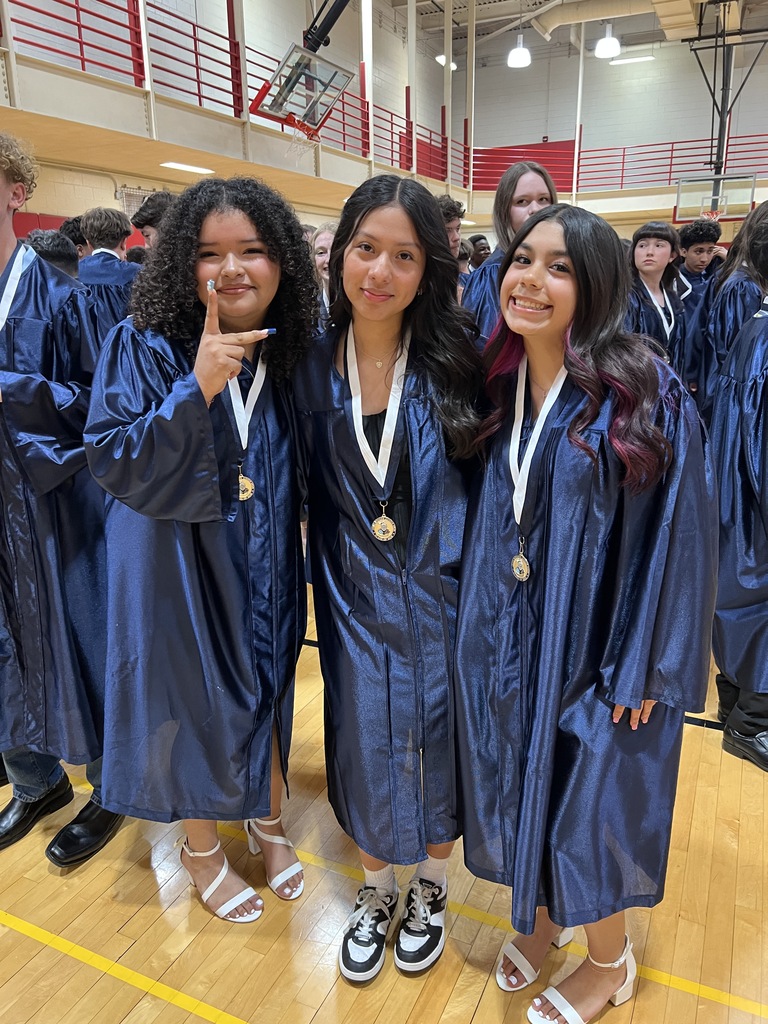 Students posing in their graduation gowns