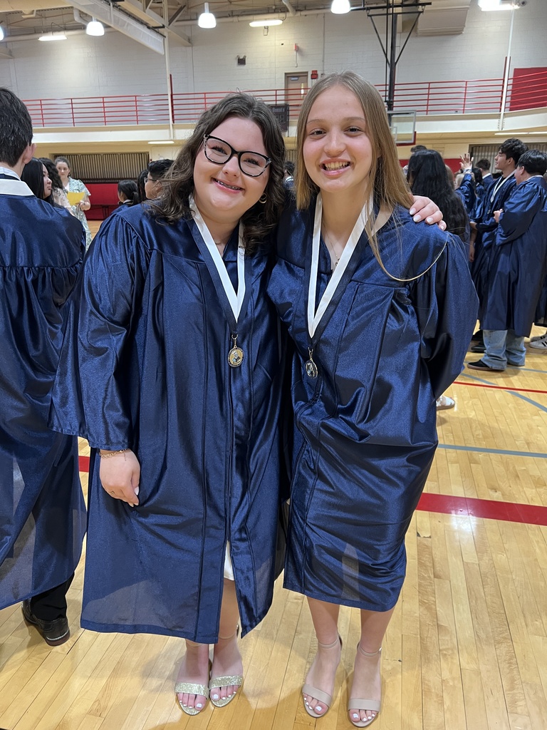 Students posing in their graduation gowns