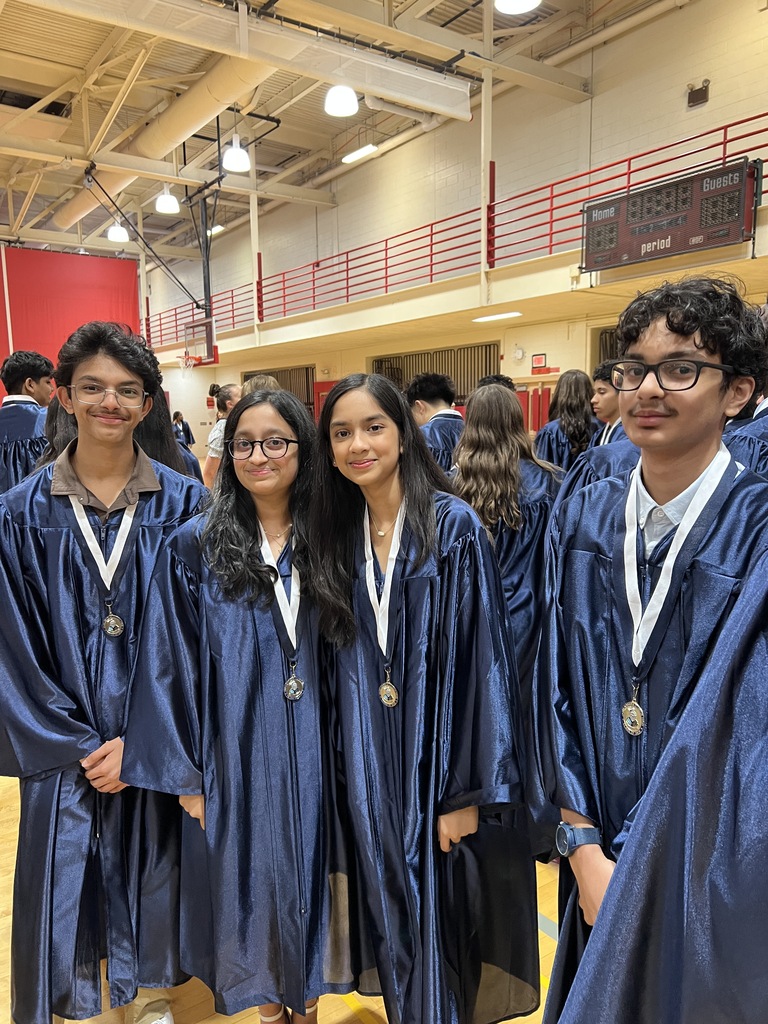 Students posing in their graduation gowns