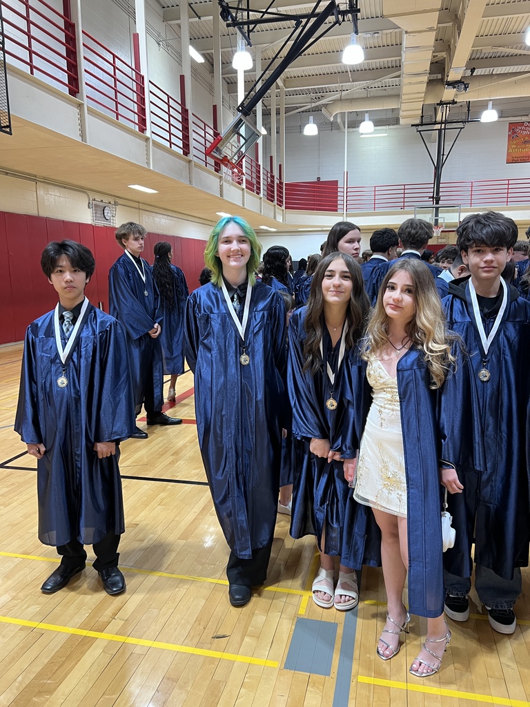 Students posing in their graduation gowns