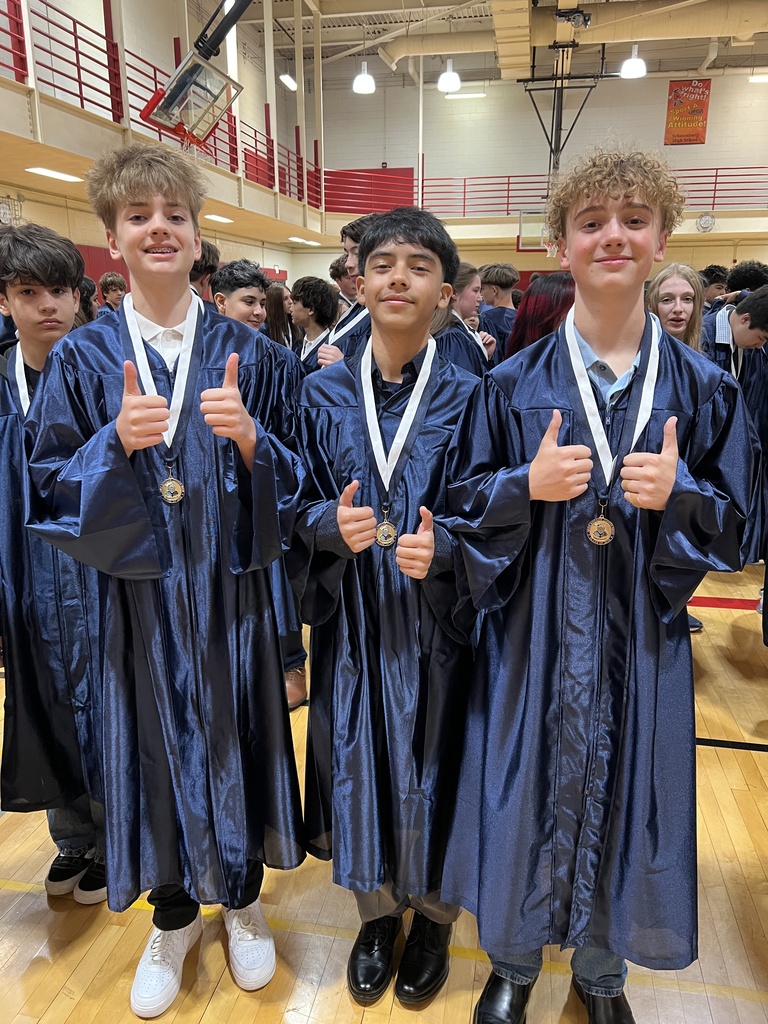 Students posing in their graduation gowns