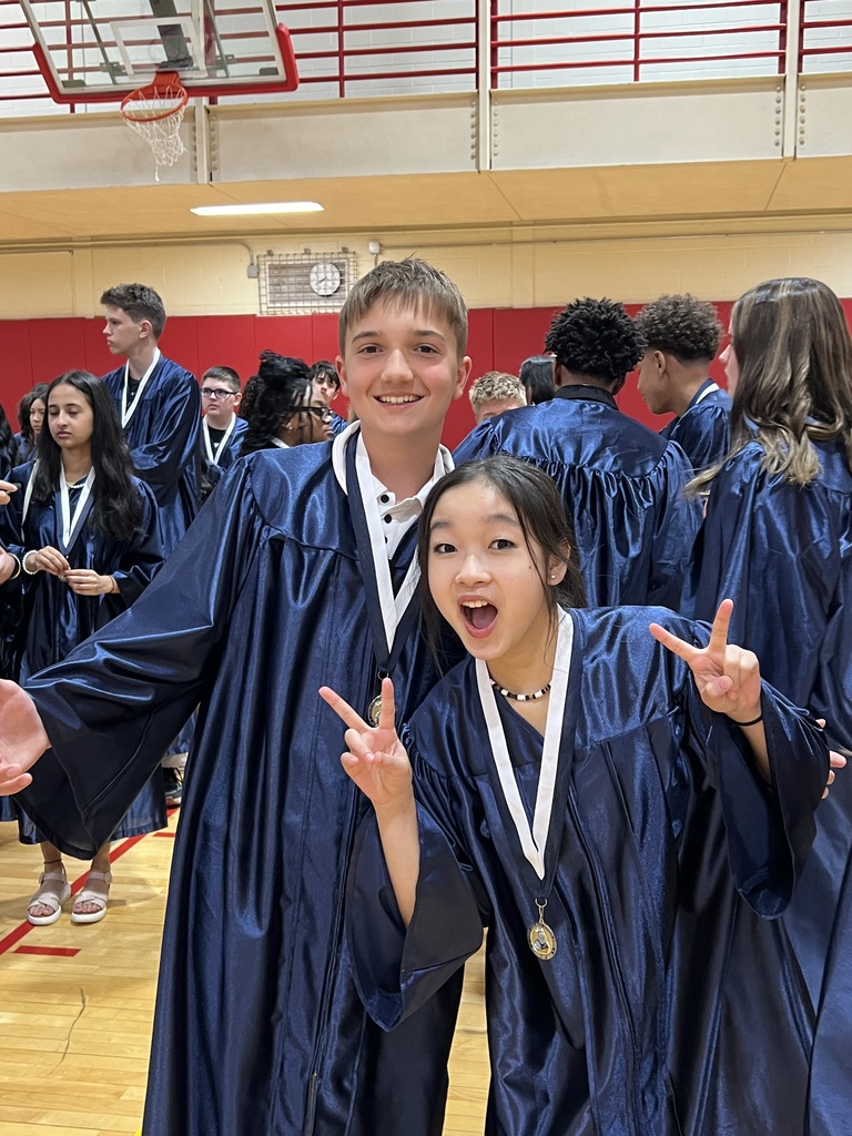 Students posing in their graduation gowns
