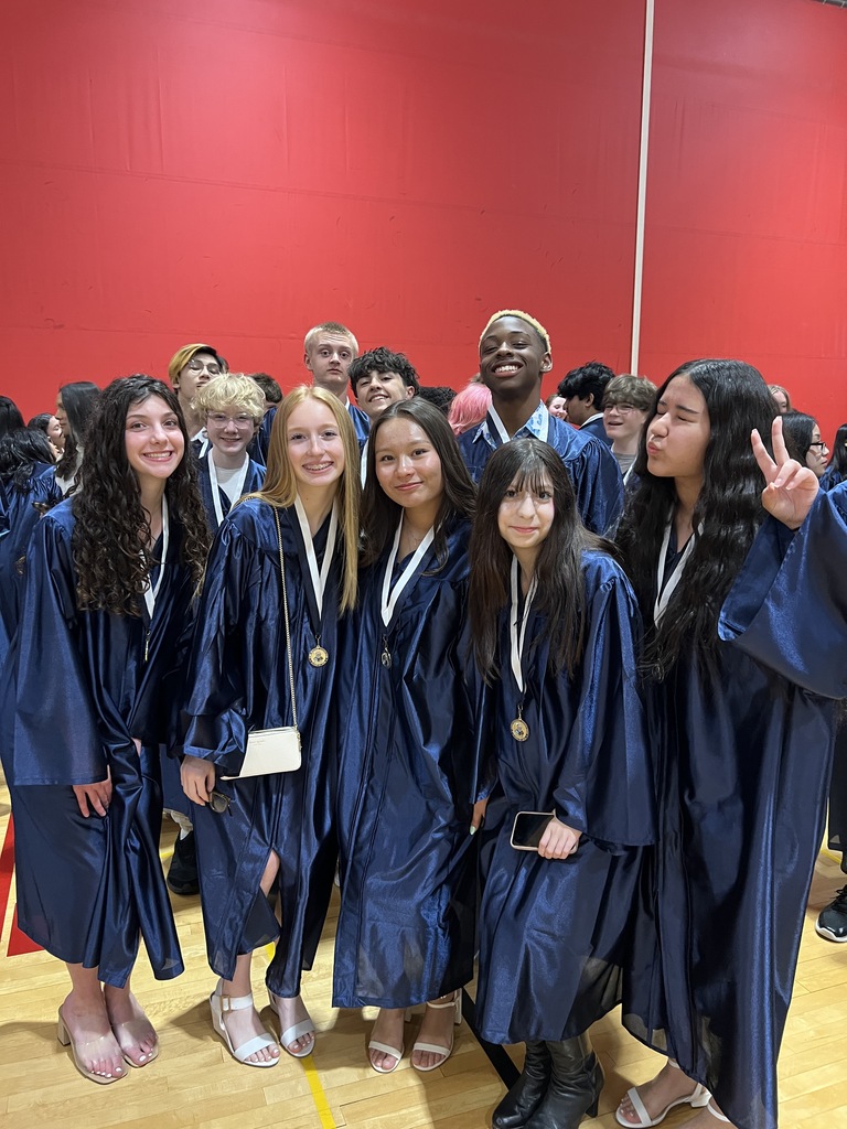 Students posing in their graduation gowns