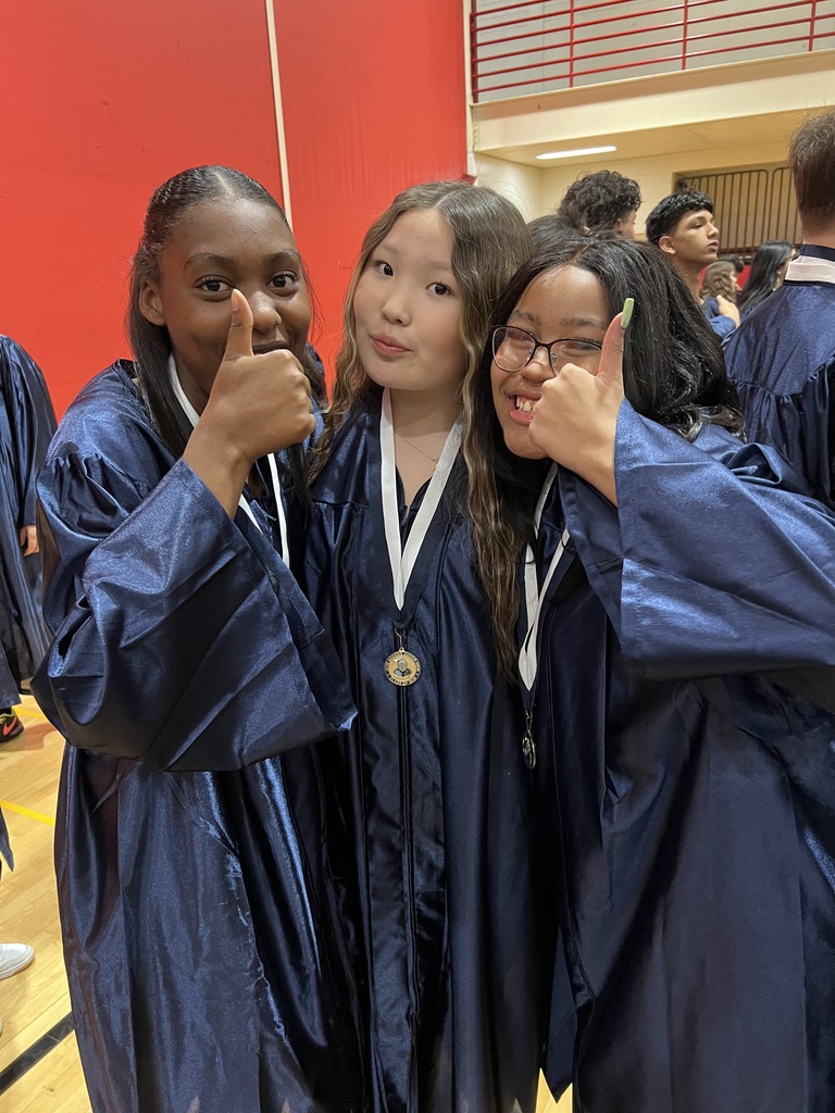 Students posing in their graduation gowns