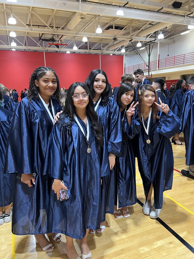 Students posing in their graduation gowns