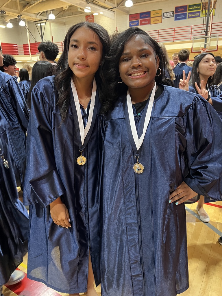 Students posing in their graduation gowns