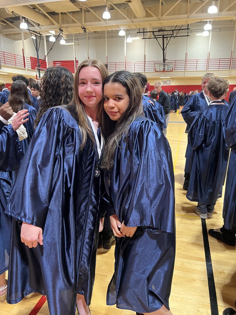 Students posing in their graduation gowns