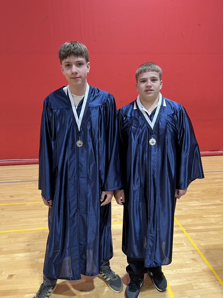 Students posing in their graduation gowns