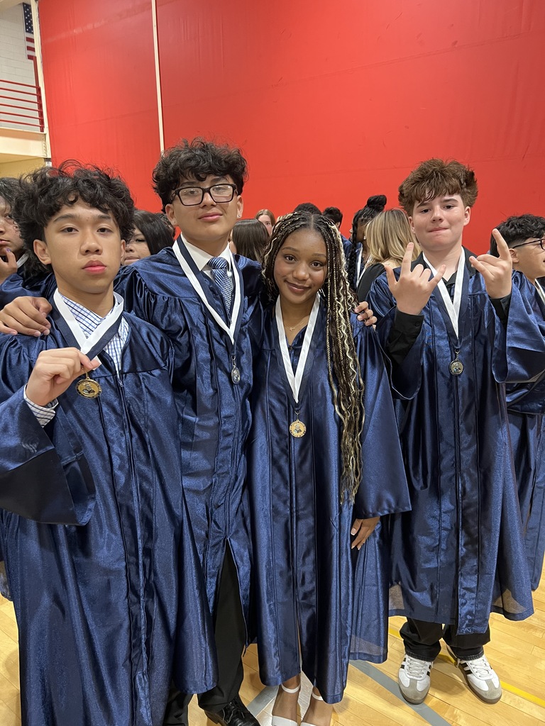 Students posing in their graduation gowns