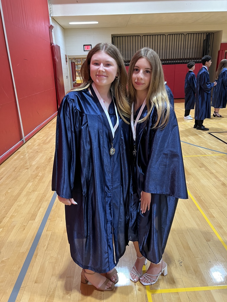 Students posing in their graduation gowns