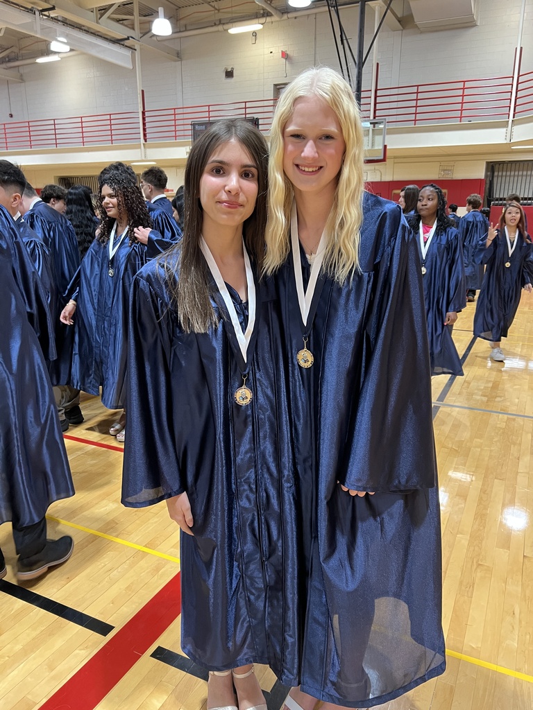 Students posing in their graduation gowns