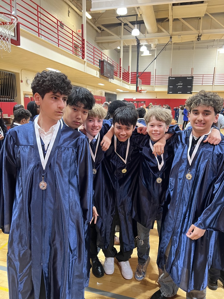 Students posing in their graduation gowns