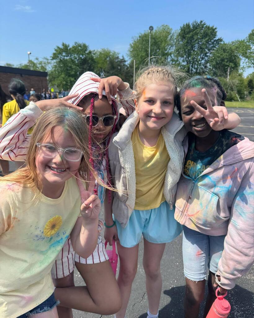4 students after field day with color run paint all over them
