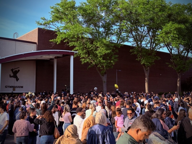 Families wait outside of Schaumburg High School to congratulate their 8th Grade Keller Junior High graduates.