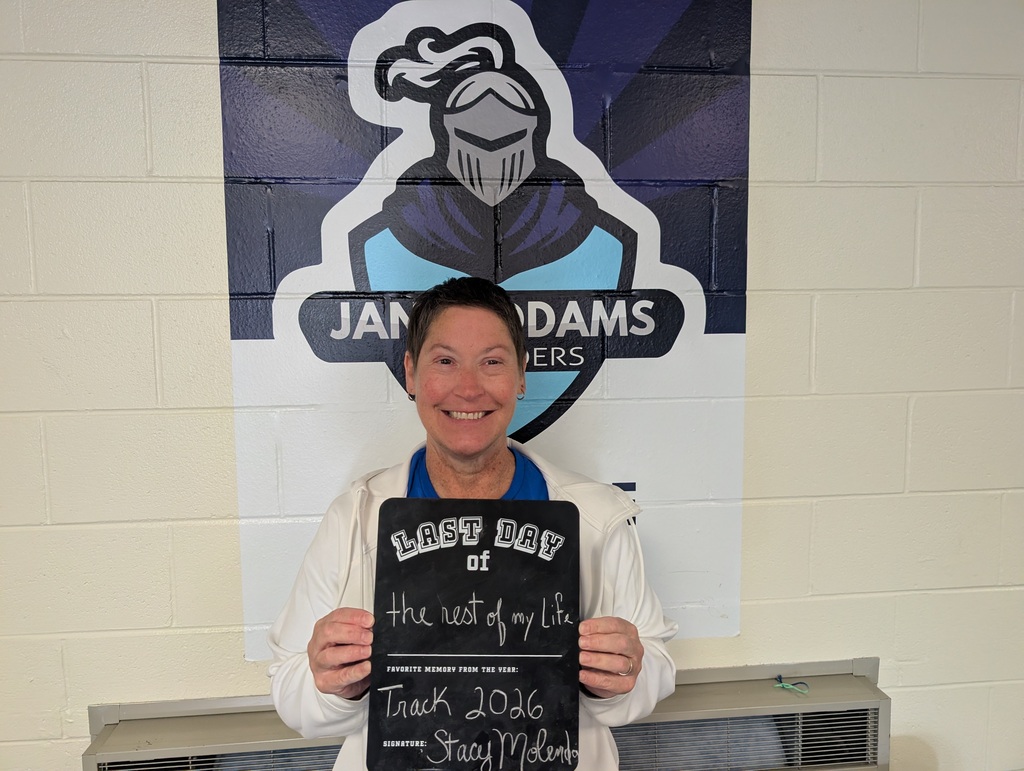 Teacher holding up a last day of school sign