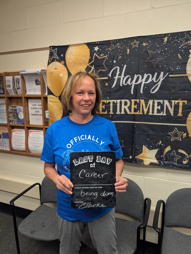 Teacher holding up a last day of school sign