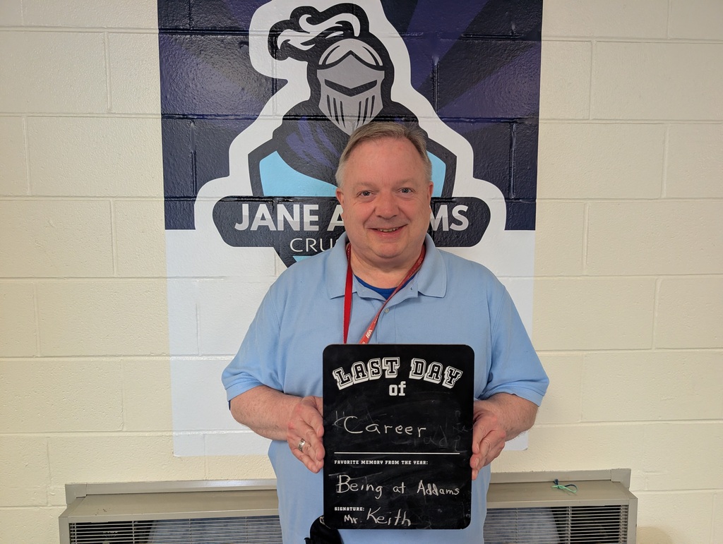 Teacher holding up a last day of school sign