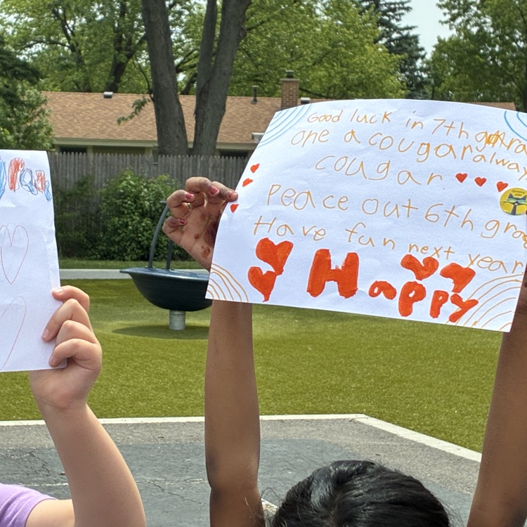 sign held up by a 2nd grade student 