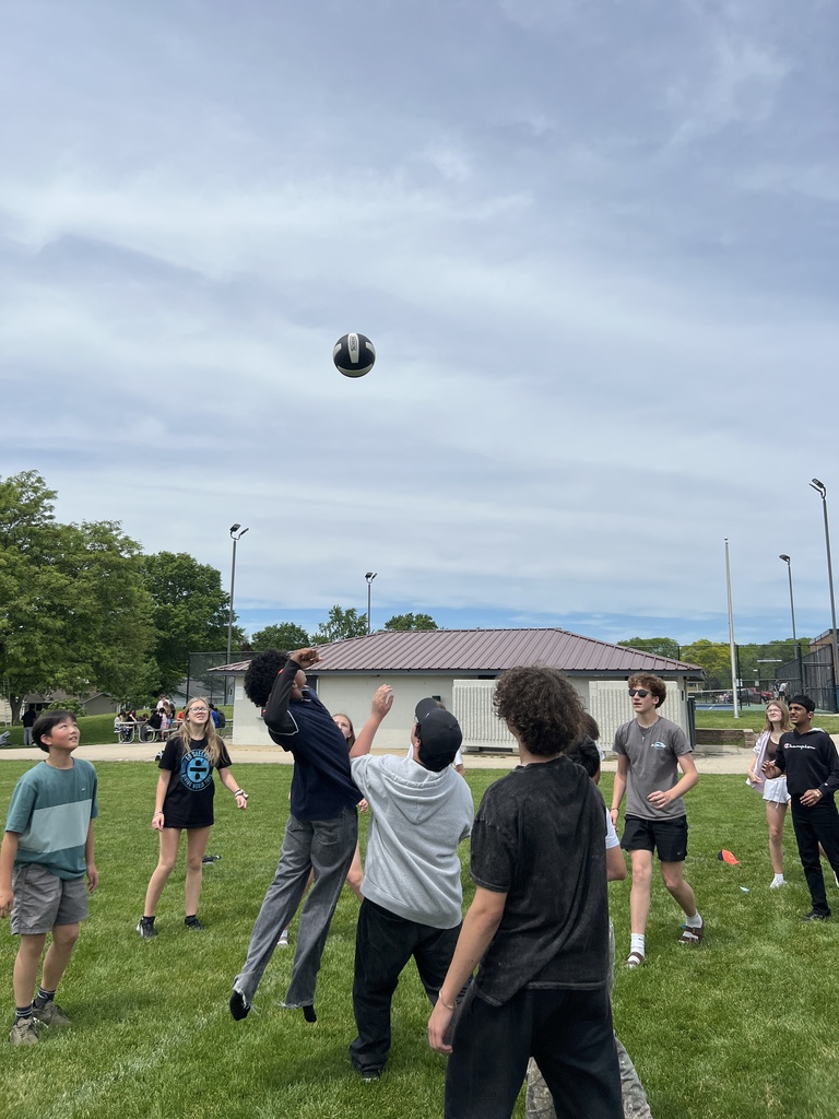 students playing volleyball outdoors