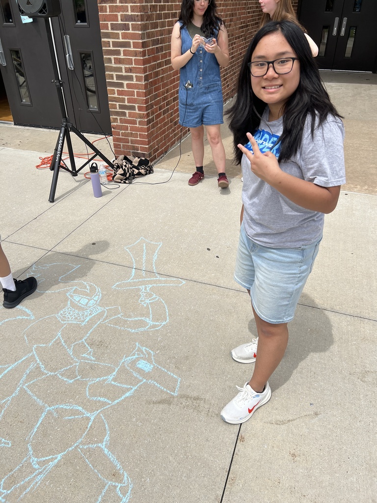 student showcasing her chalk art