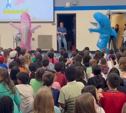 Dirksen dolphin mascots dancing