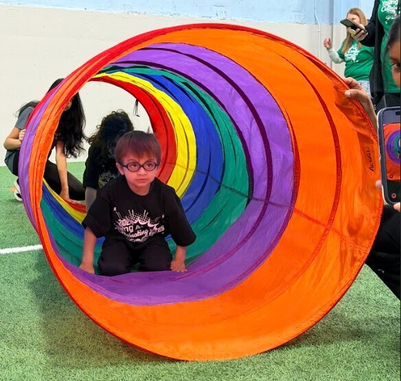 young boy in colorful tunnel