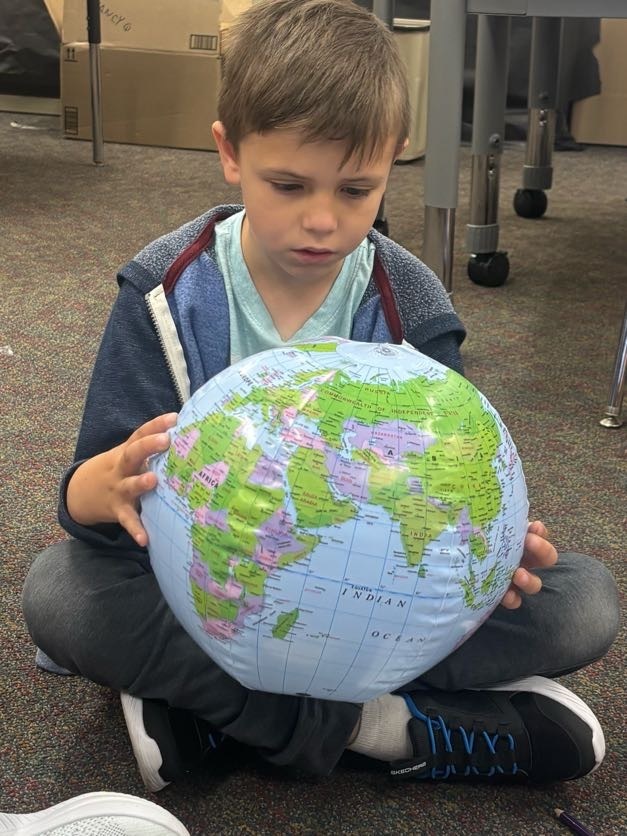 Boy studies a blow up world