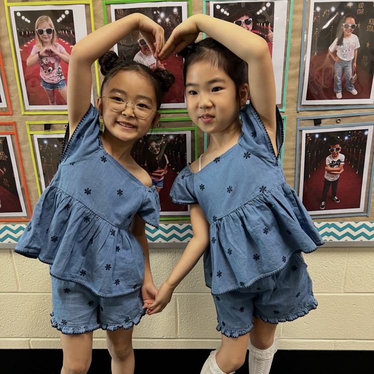 Two students making a heart
