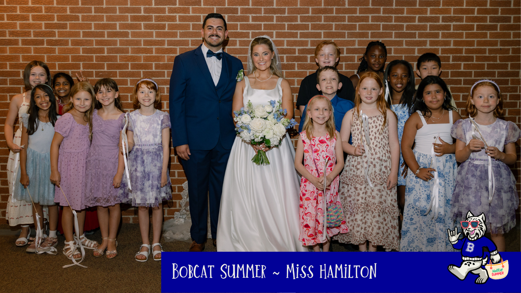Teacher with her husband and students at their wedding
