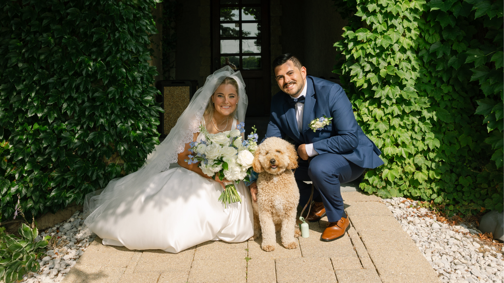 Husband and wife with their dog at their wedding photos