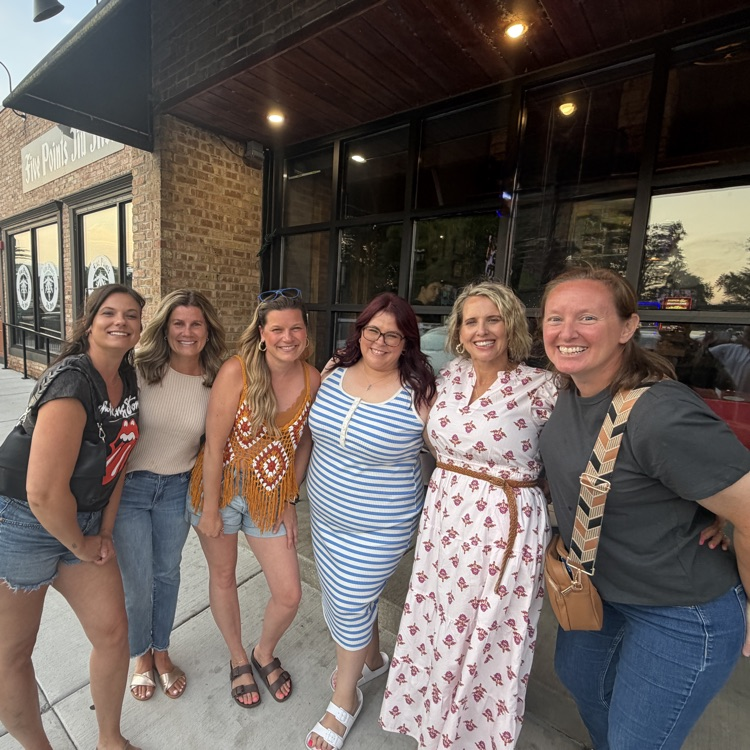 teachers in front of restaurant 