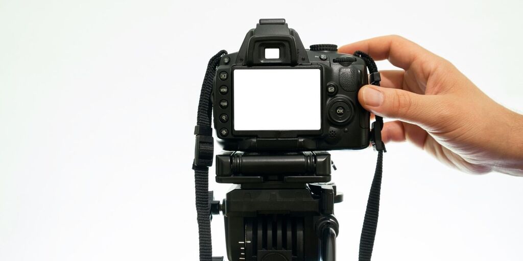 Hand holding a camera